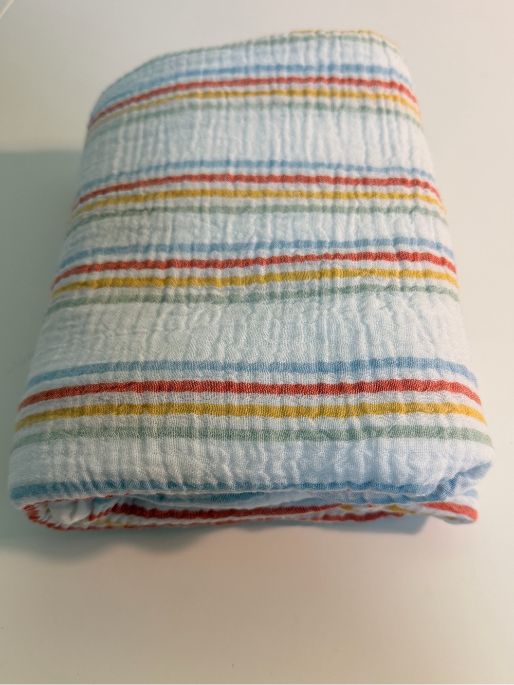 Rainbow stripe on white cotton double gauze fabric. 56” wide, 1.6 yards.